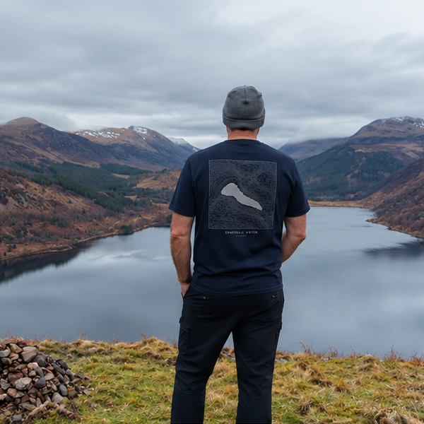 Ennerdale Water organic cotton navy T-shirt with contour print, worn overlooking Ennerdale Water in the Lake District